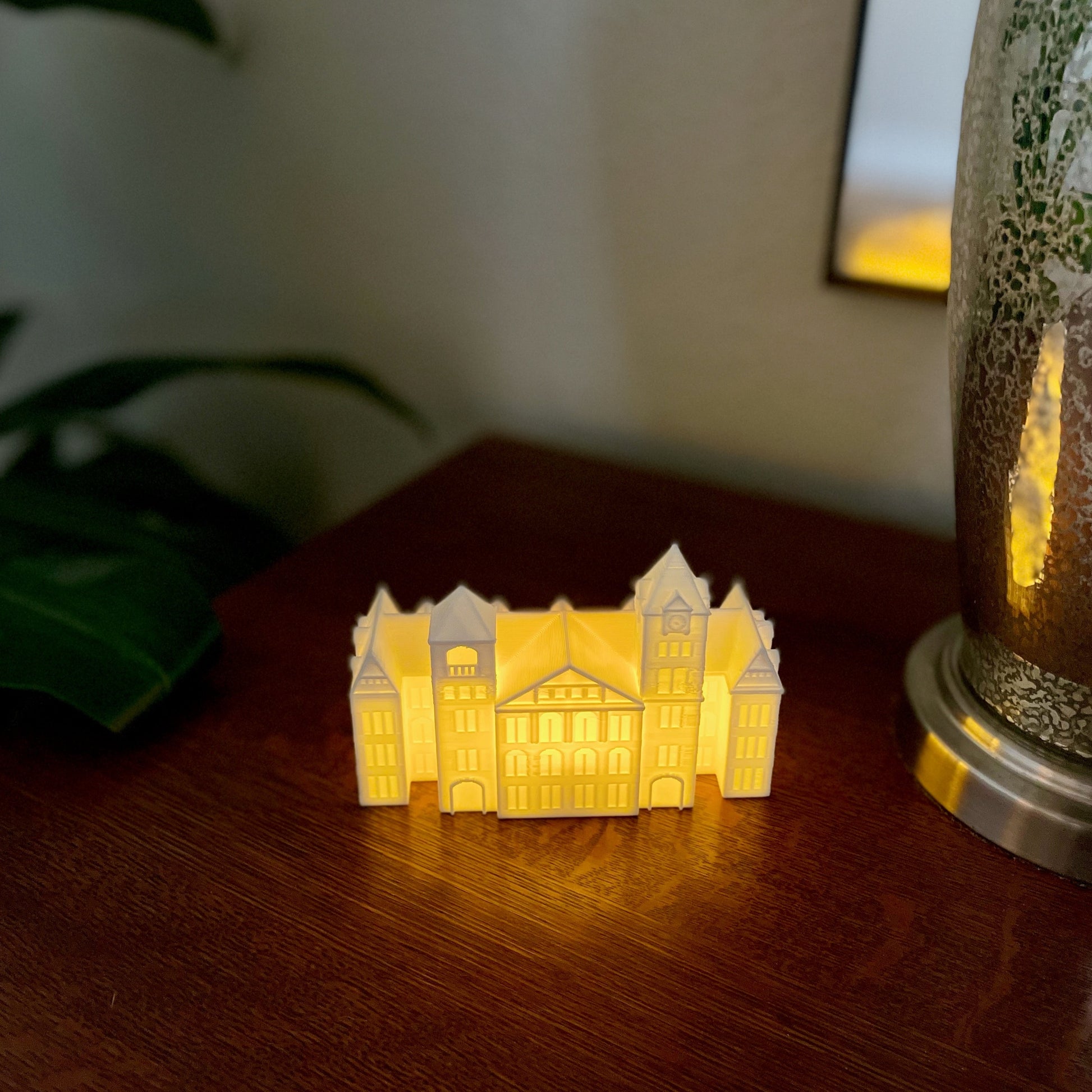 The Auburn university graduation keepsake, used as home decor and shown on a bedroom side table.