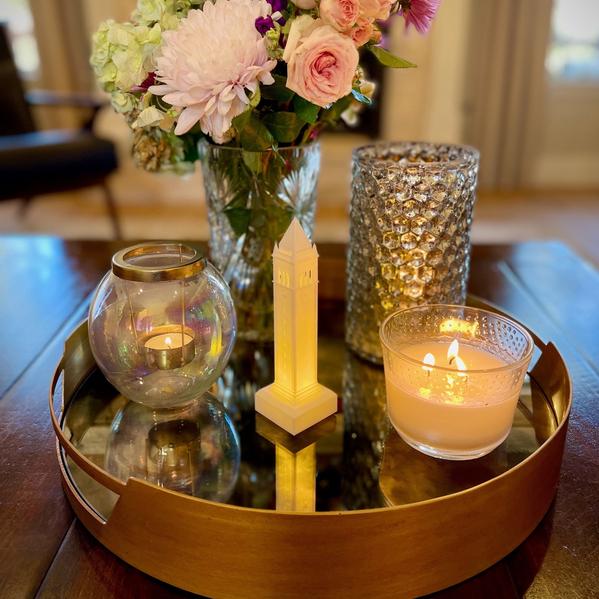 The Berkeley Campanile lighted figurine, shown styled on a living room tray.