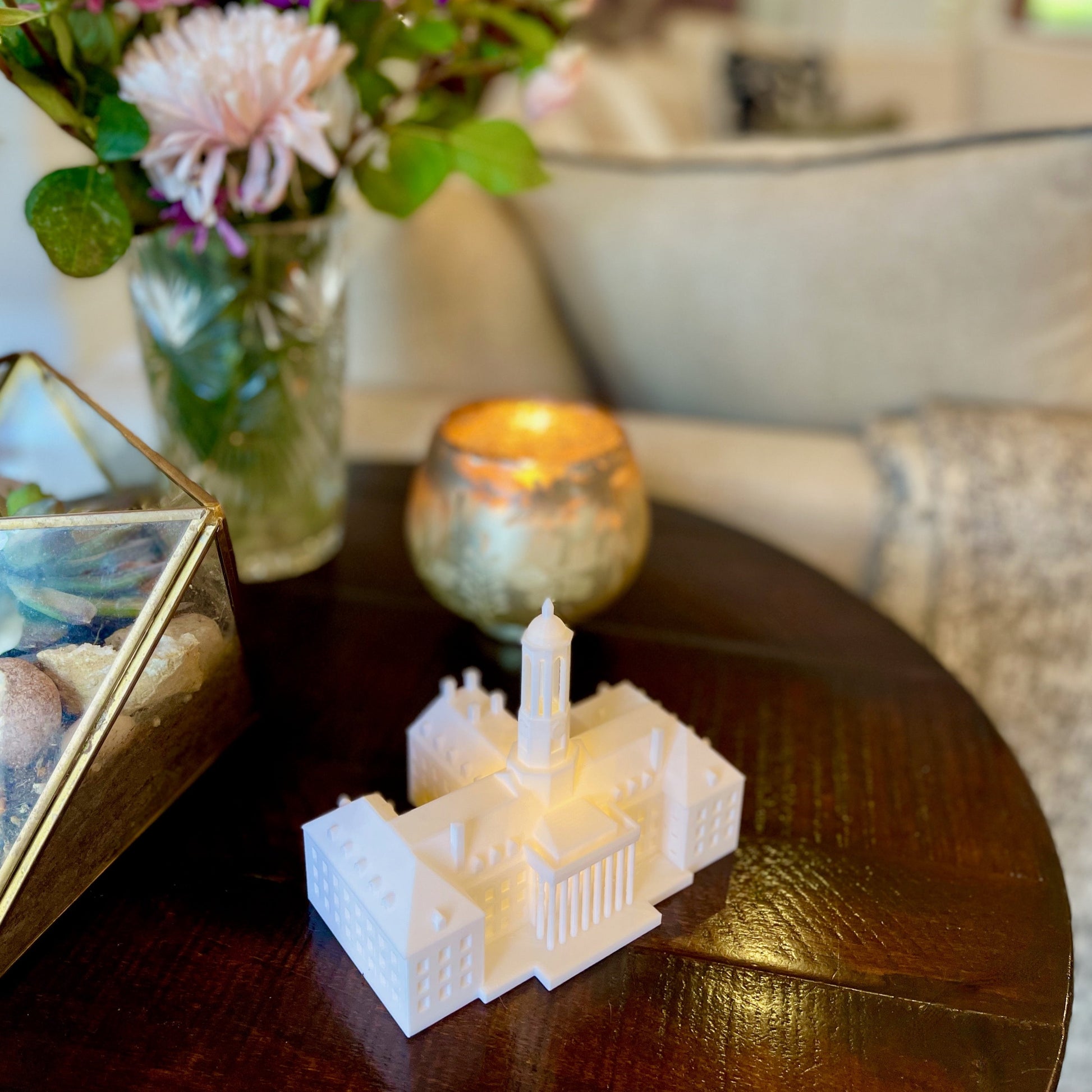 The Penn State lighted Old Main figurine, shown on a side table.