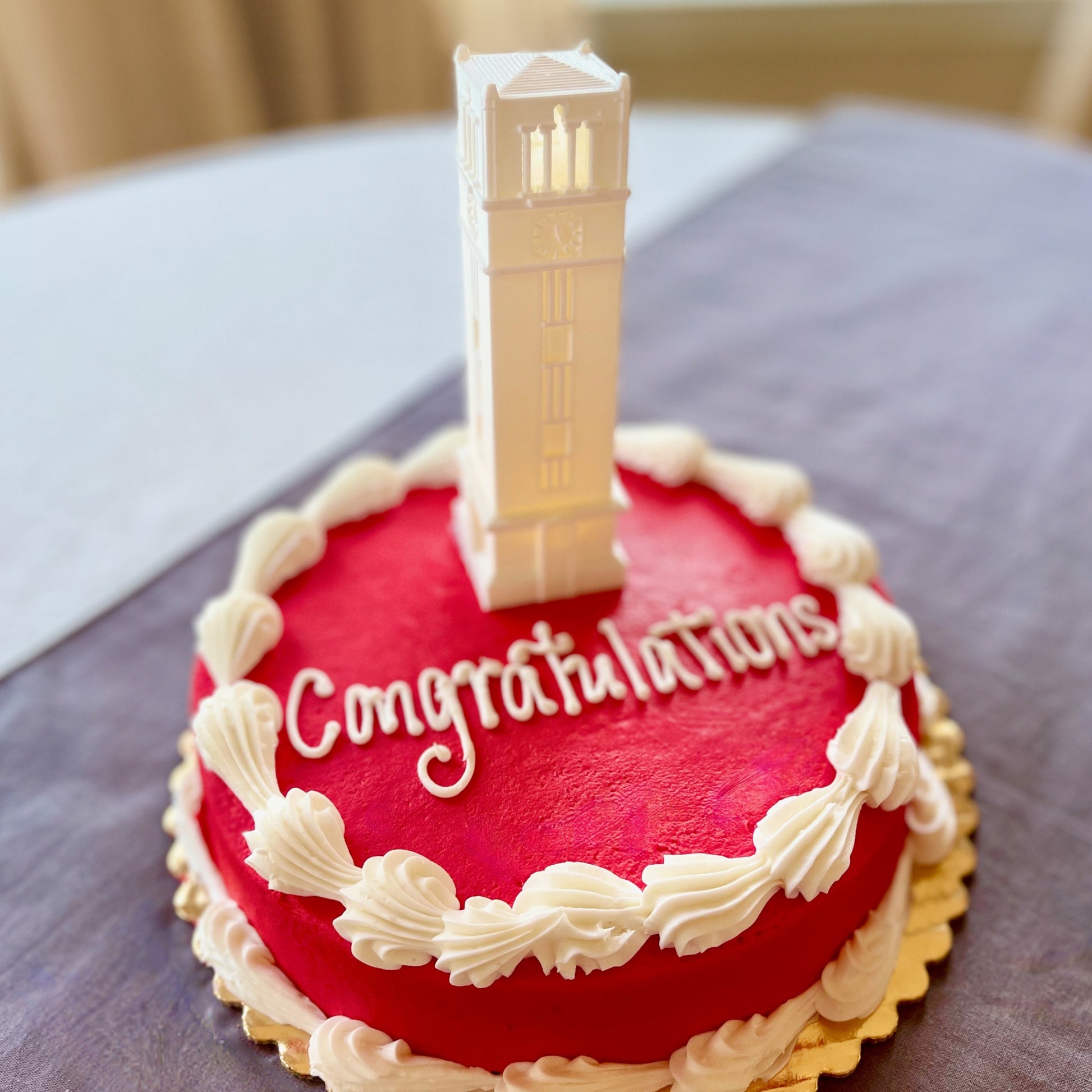 The lighted NC State cake topper, shown on an NC State graduation cake.