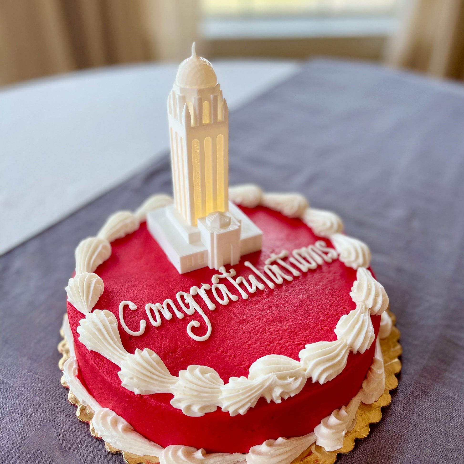 The Stanford University cake topper, shown on a red Stanford graduation cake.