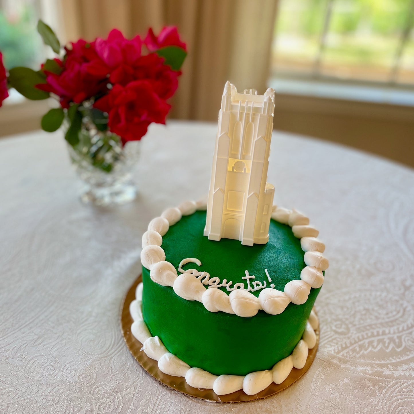 The Michigan State cake topper, shown on a MSU graduation cake.