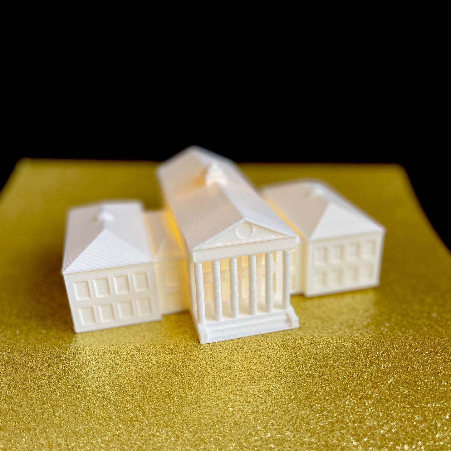 The lighted Ole Miss figurine, shown against a gold background.