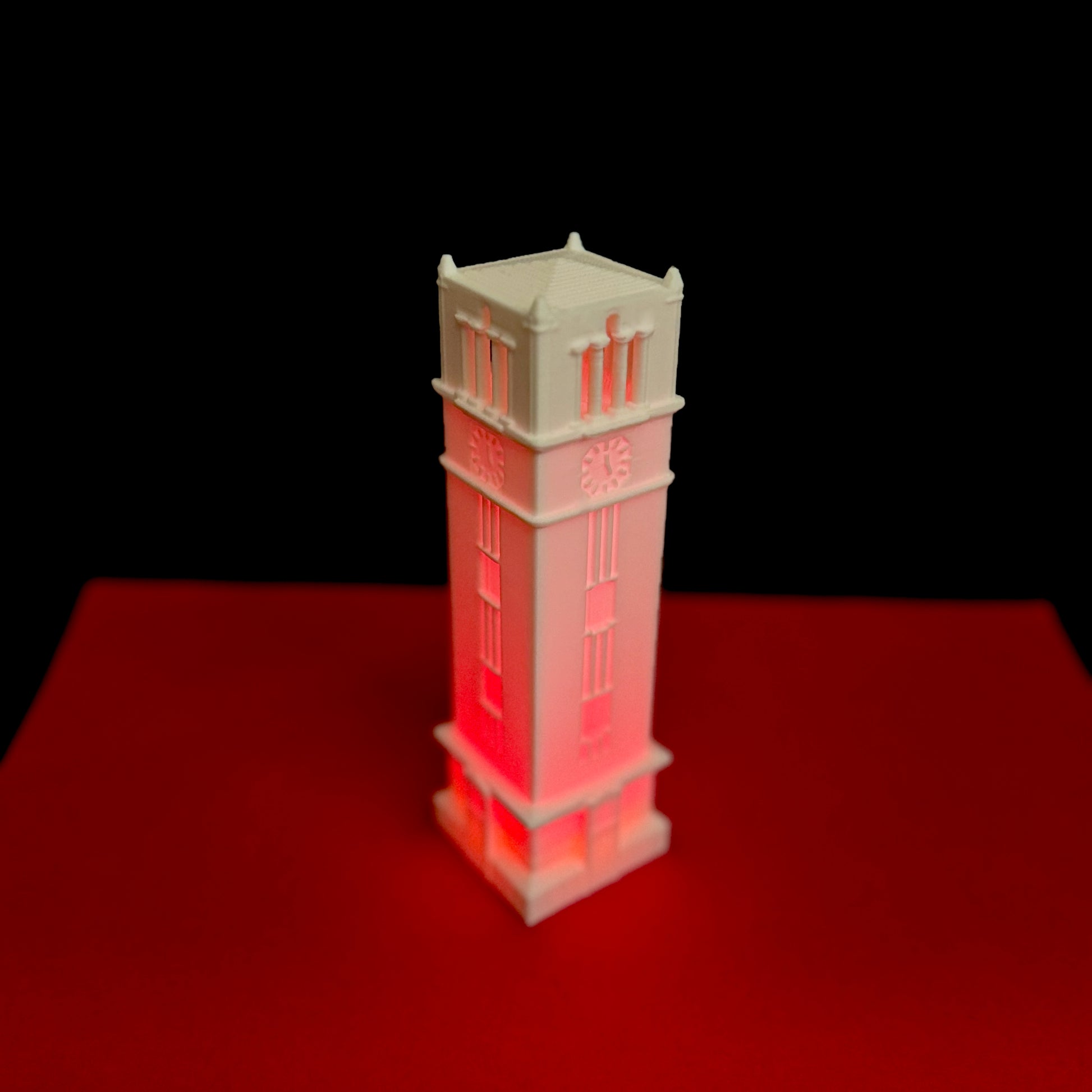 The NC State bell tower light, shown in red.