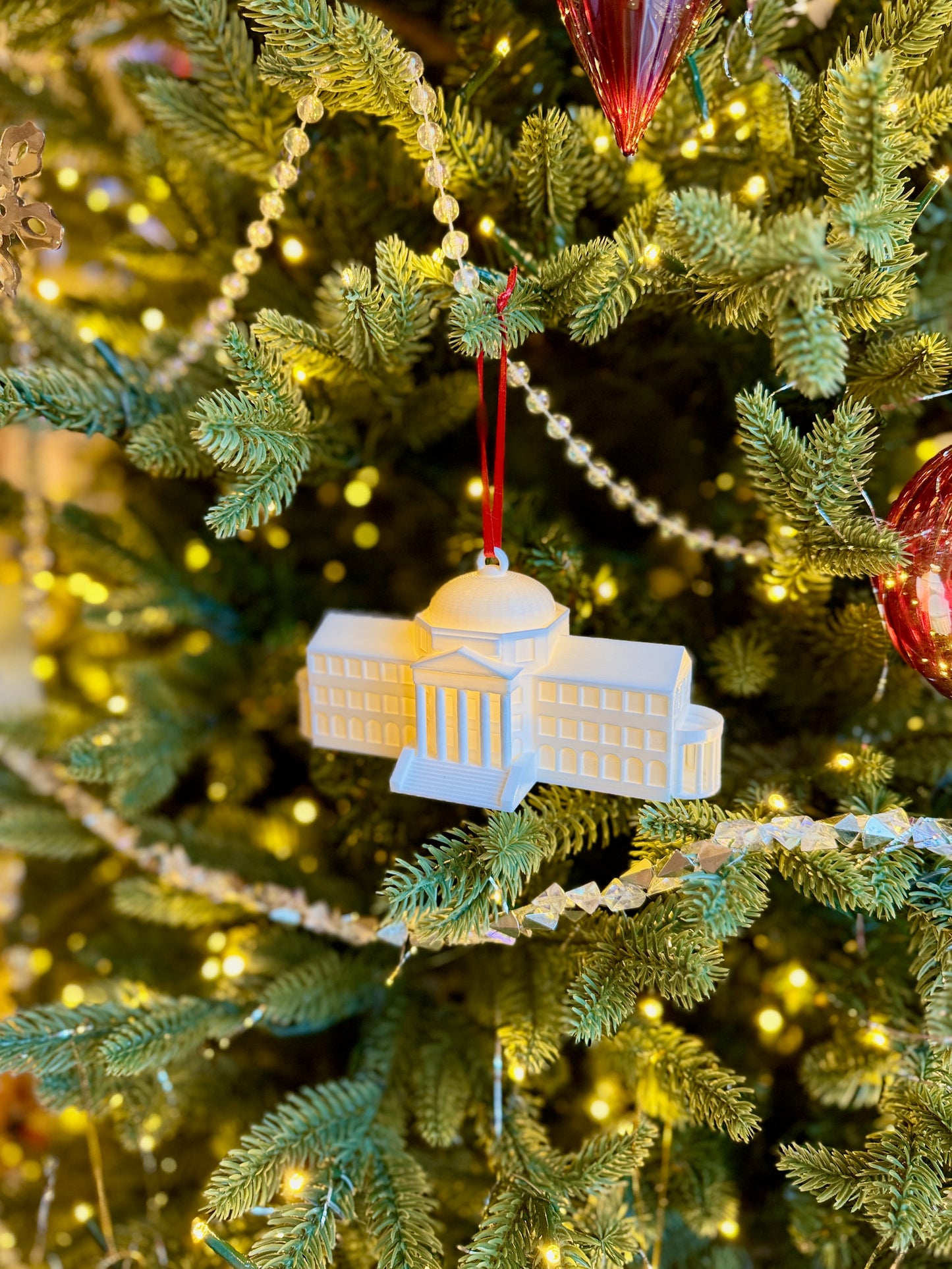 The SMU keepsake ornament shown on a Christmas tree.