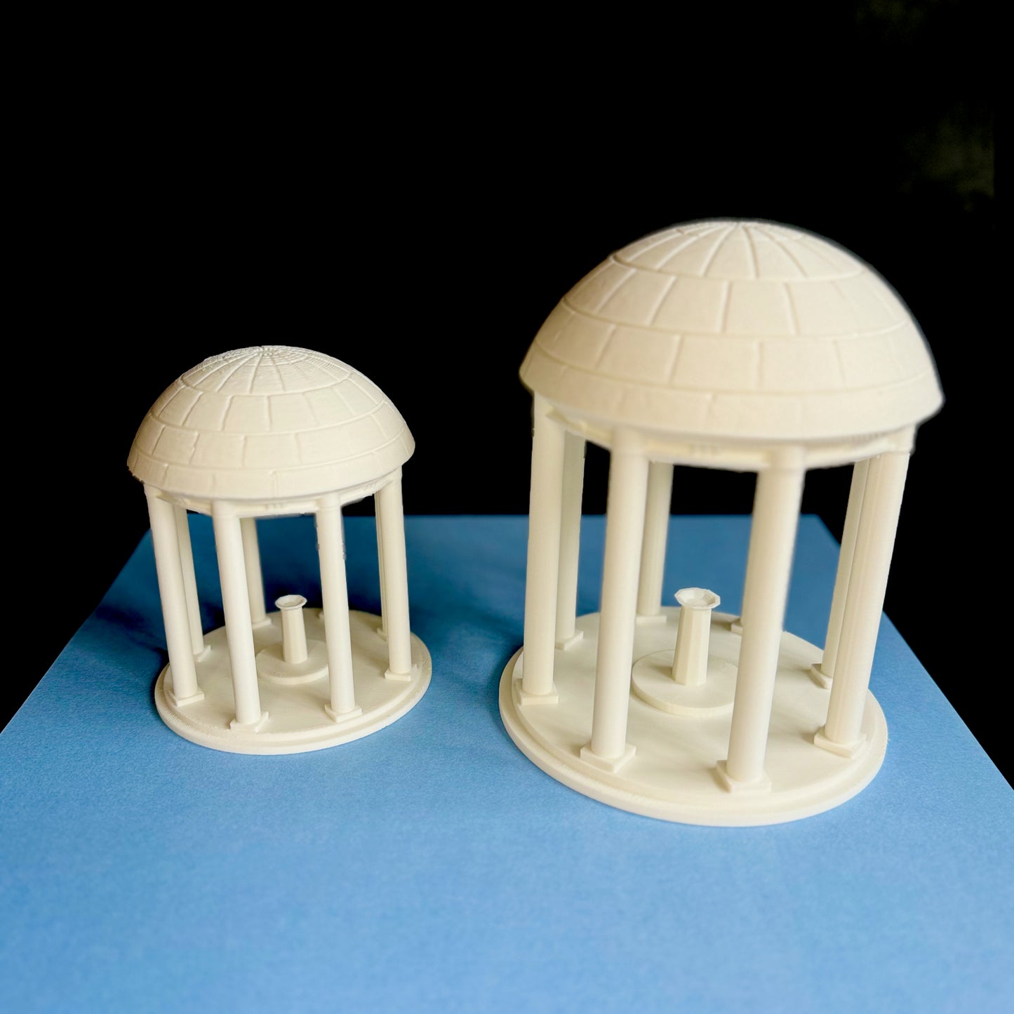 The UNC Old Well figurines, shown in two sizes.