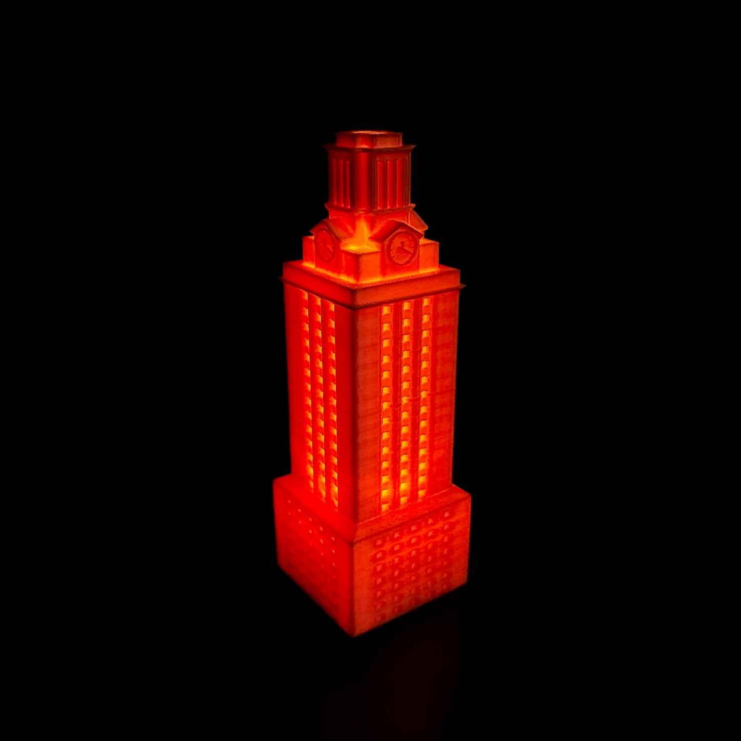 The lighted University of Texas Tower figurine, shown in orange.