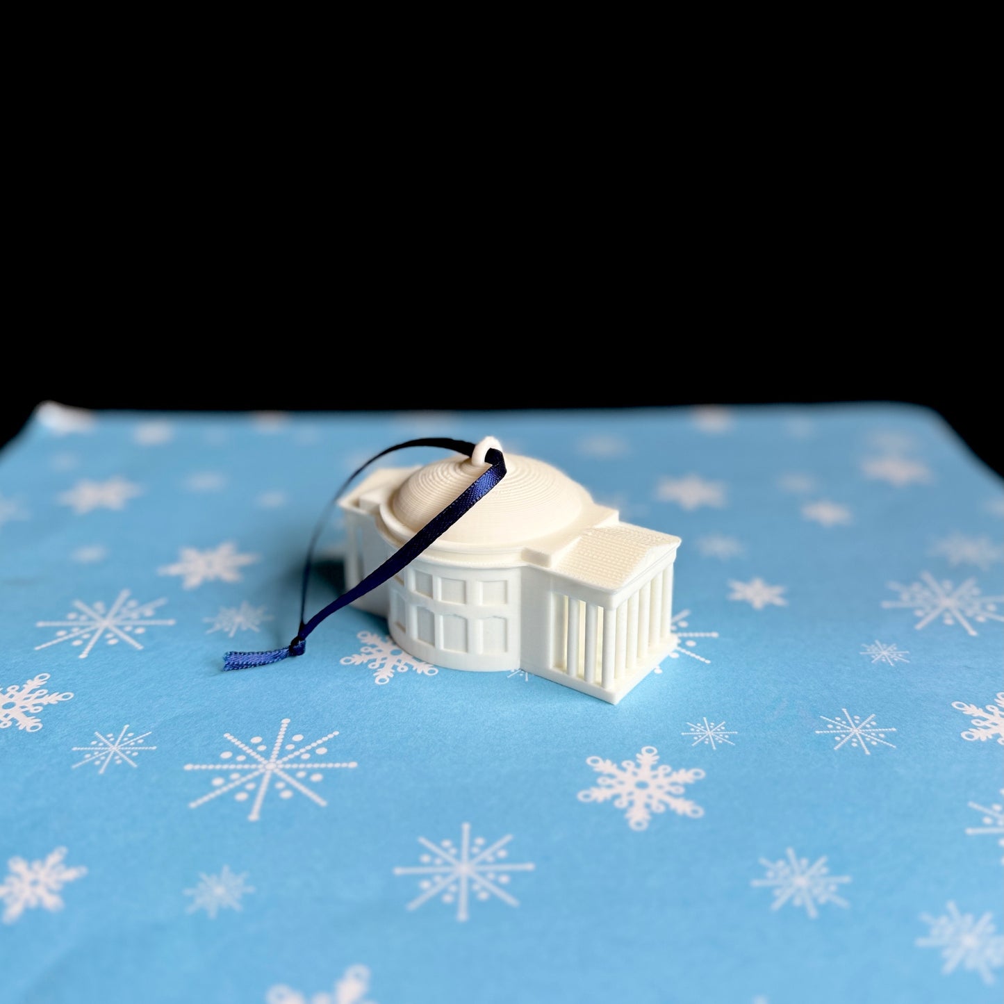 The UVA Rotunda ornament shown against a holiday background.