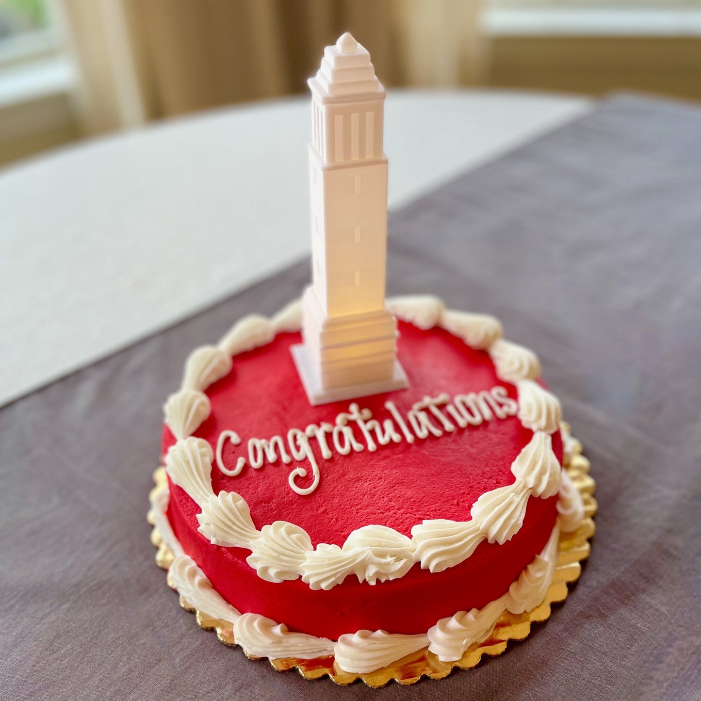 The lighted University of Alabama cake topper, shown on an Alabama graduation cake.