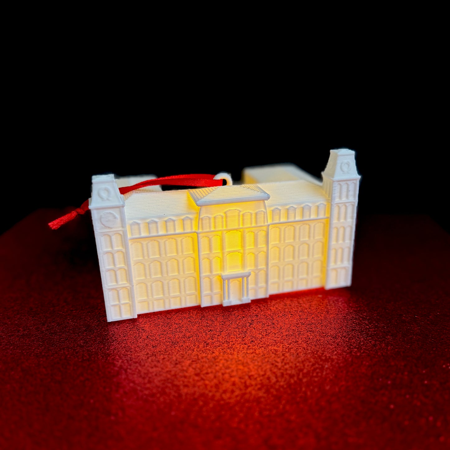 The University of Arkansas college ornament with a light, designed as a replica of the Old Main campus building in Fayetteville.