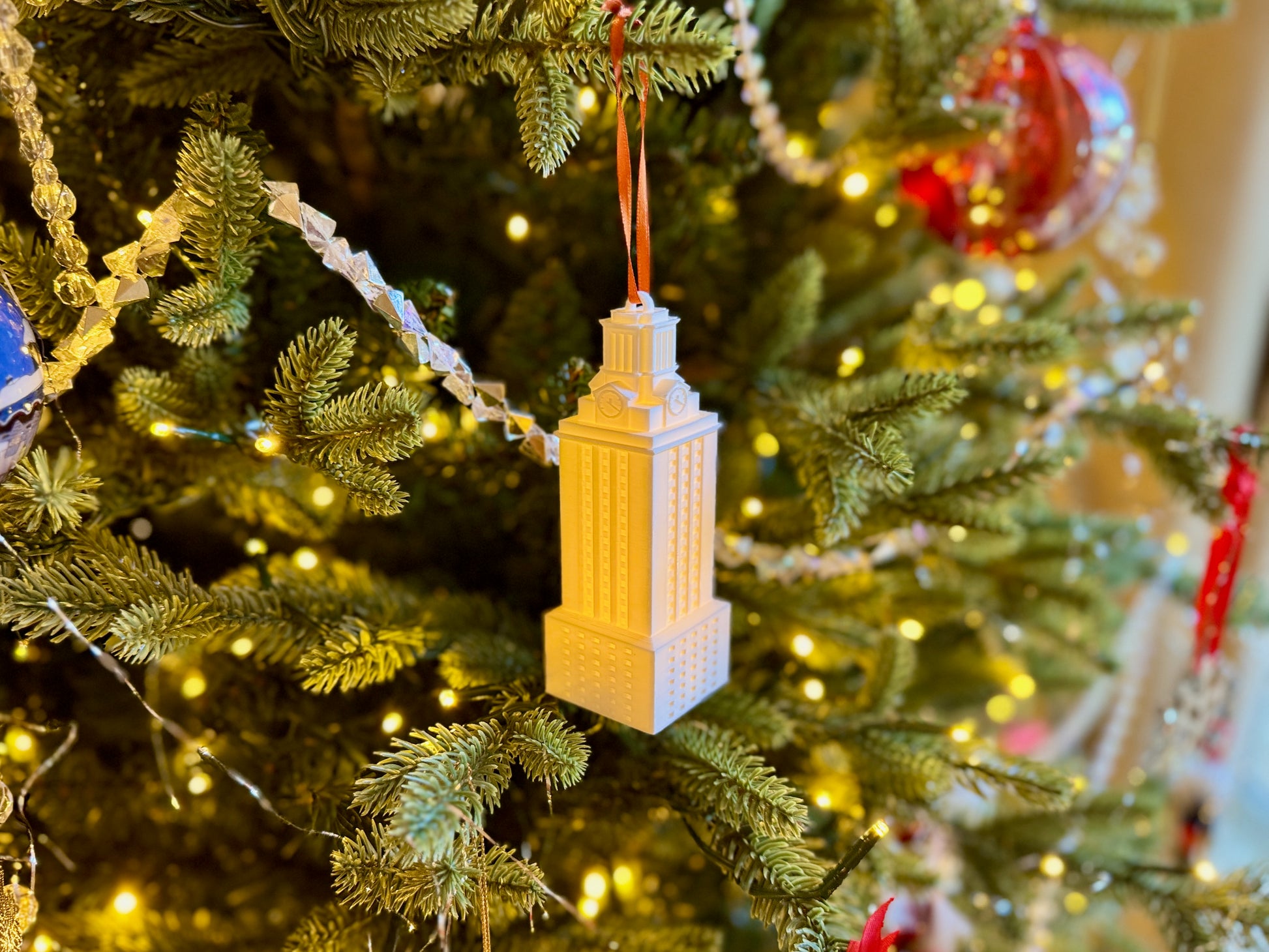 University of Texas ornament of the UT Tower shown on a Christmas tree.
