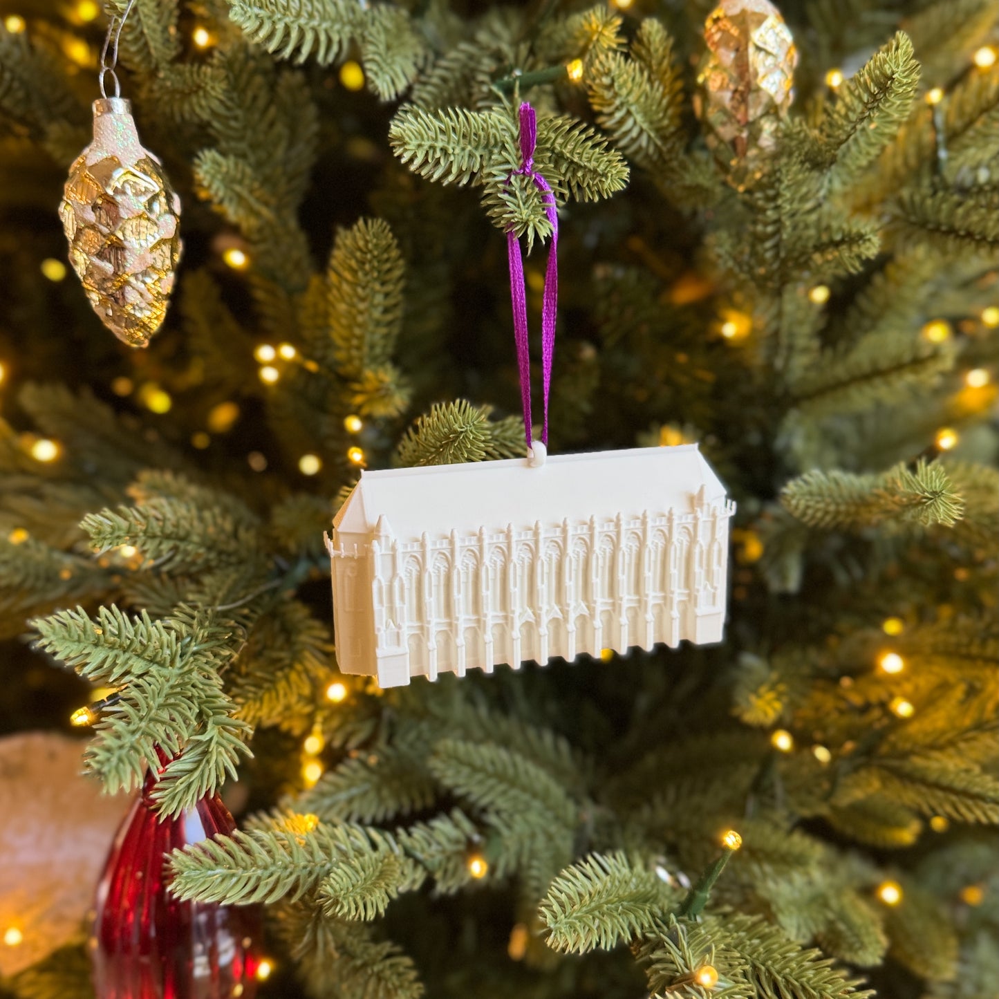 The University of Washington ornament depicting Suzzallo Library, shown on a Christmas tree.