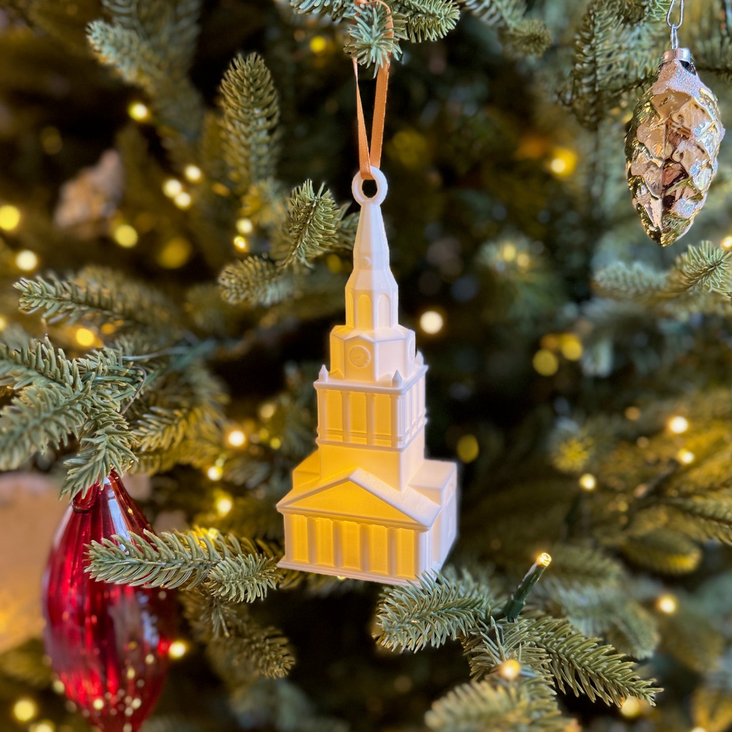 The Wake Forest ornament depicting Wait Chapel, shown on a Christmas tree.