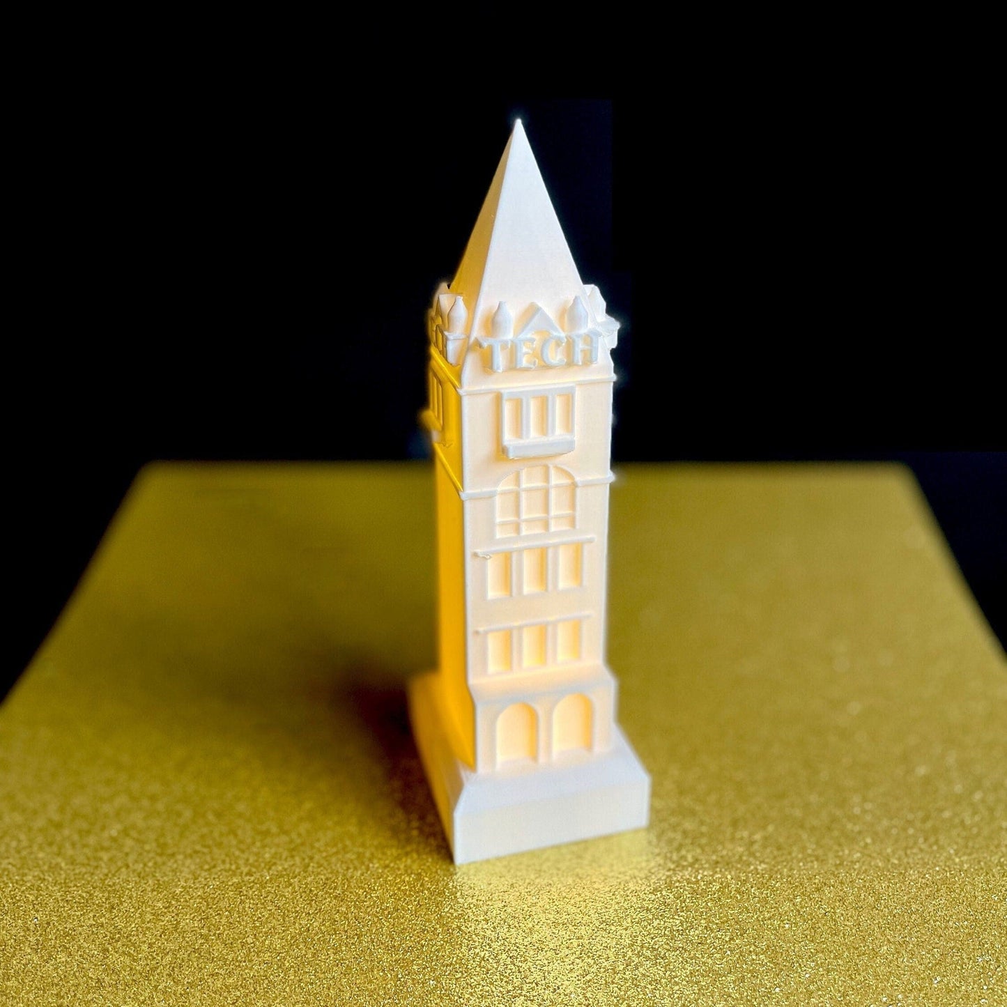 The Georgia Tech lighted figurine, shown against a gold background.