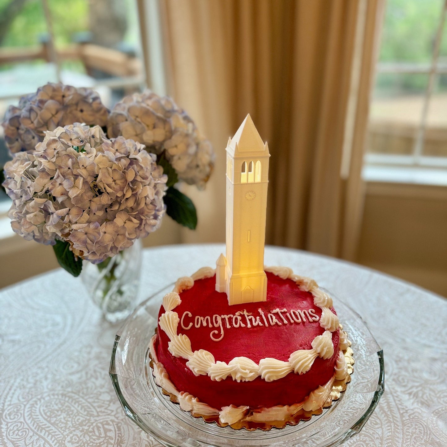 The lighted Iowa State cake topper, designed in honor of the ISU Campanile.