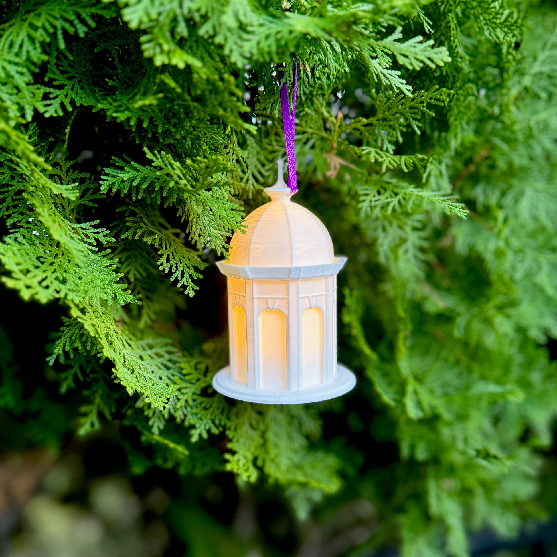 The lighted ECU Cupola ornament, shown on a Christmas tree.