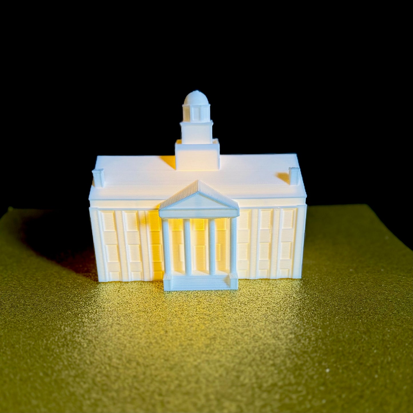 Front view of the lighted Iowa Old Capitol cake topper.