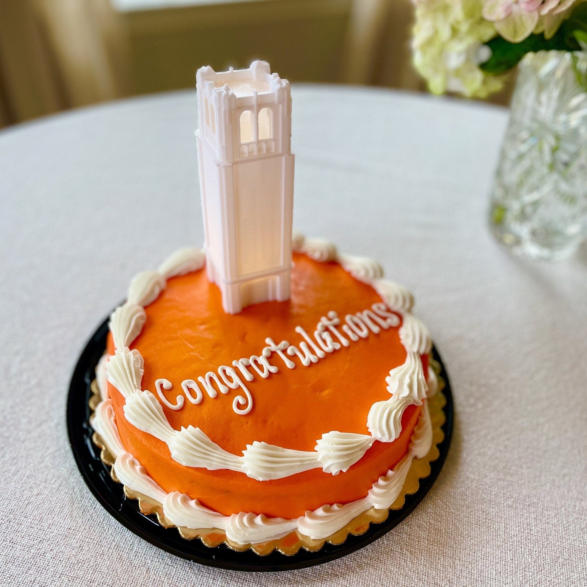 The University of Florida cake topper light, shown on an orange graduation cake.