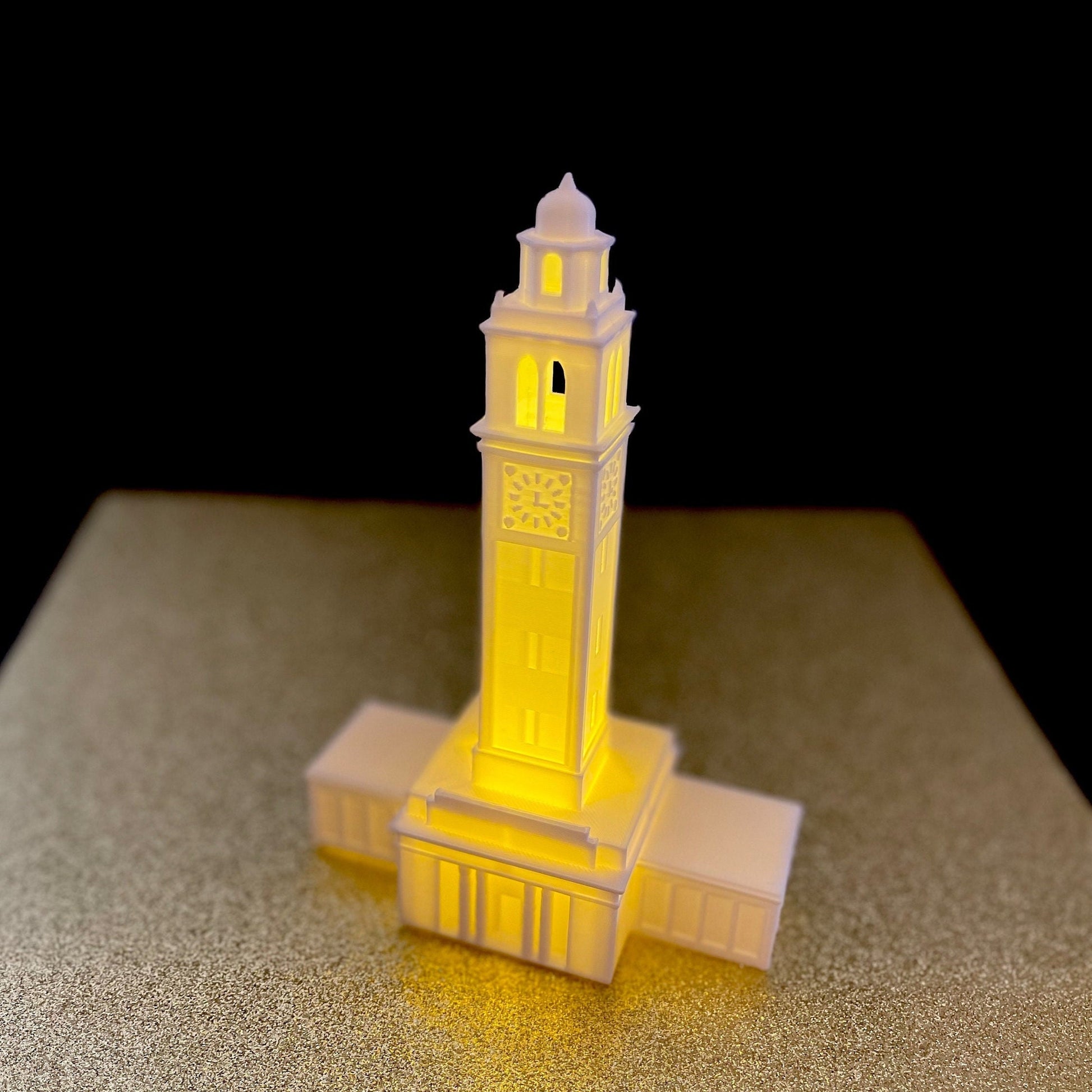 The LSU Memorial Tower light, shown against a gold background.