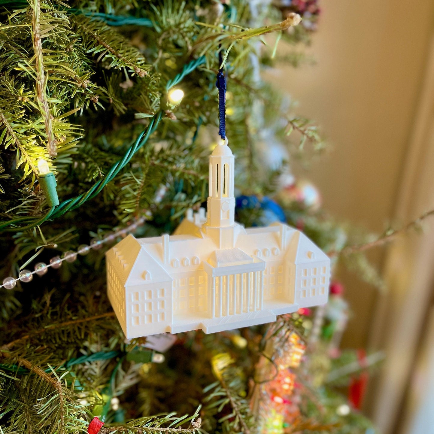 The lighted Penn State ornament, shown on a Christmas tree.