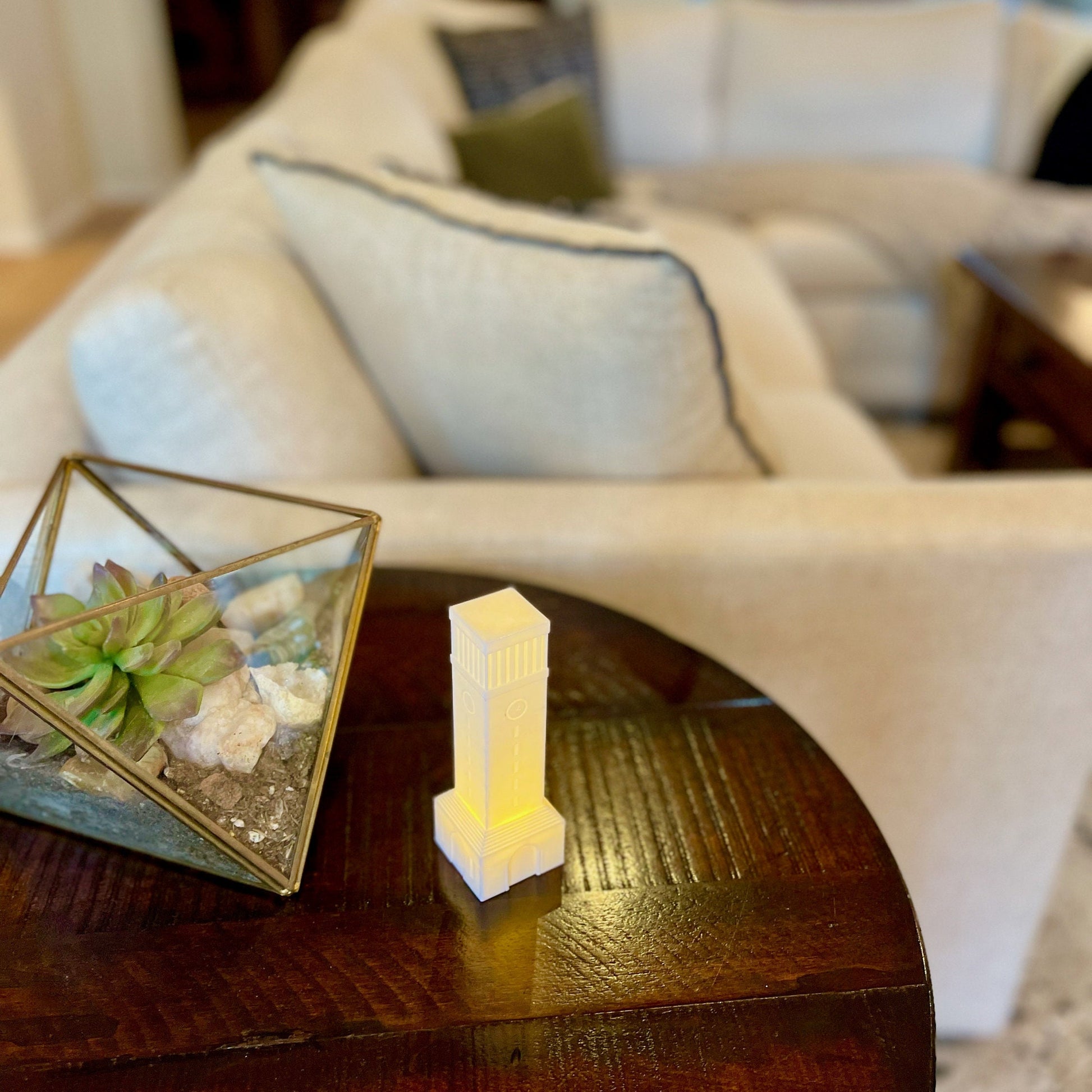 The lighted Texas A&M campus keepsake, shown on a living room side table.