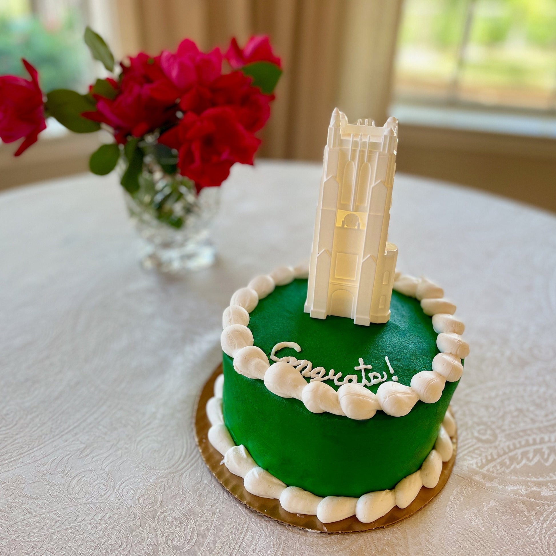 The lighted Michigan State cake topper, shown on a green Michigan State University graduation cake.