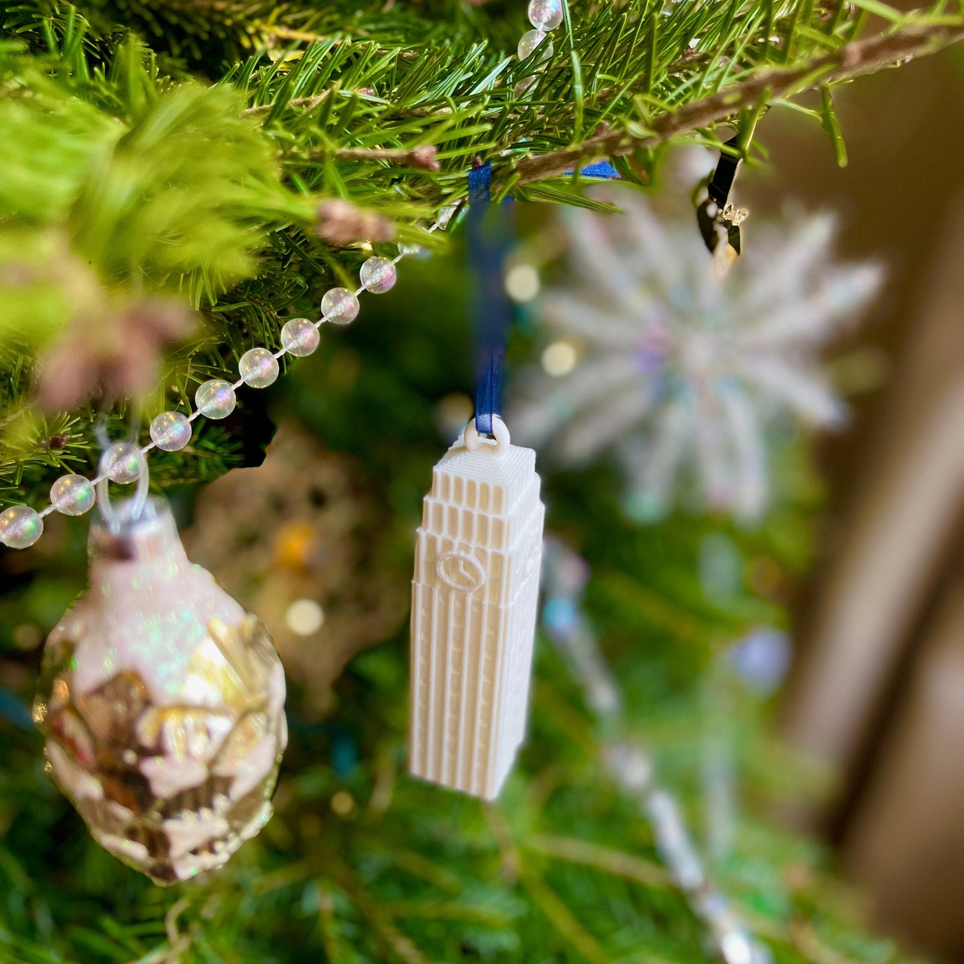 The University of Michigan campus ornament, shown on a Christmas tree.