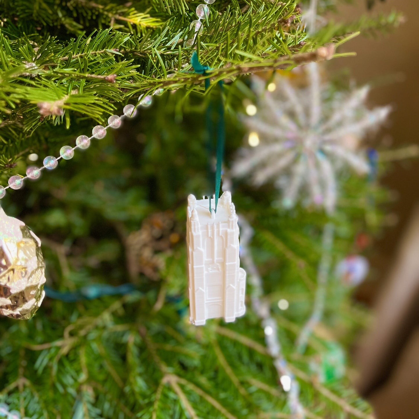 The Michigan State University campus ornament, shown on a Christmas tree.