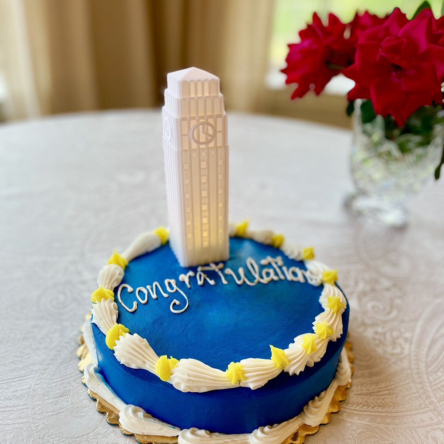 The University of Michigan cake topper, shown on a Michigan Wolverines cake.