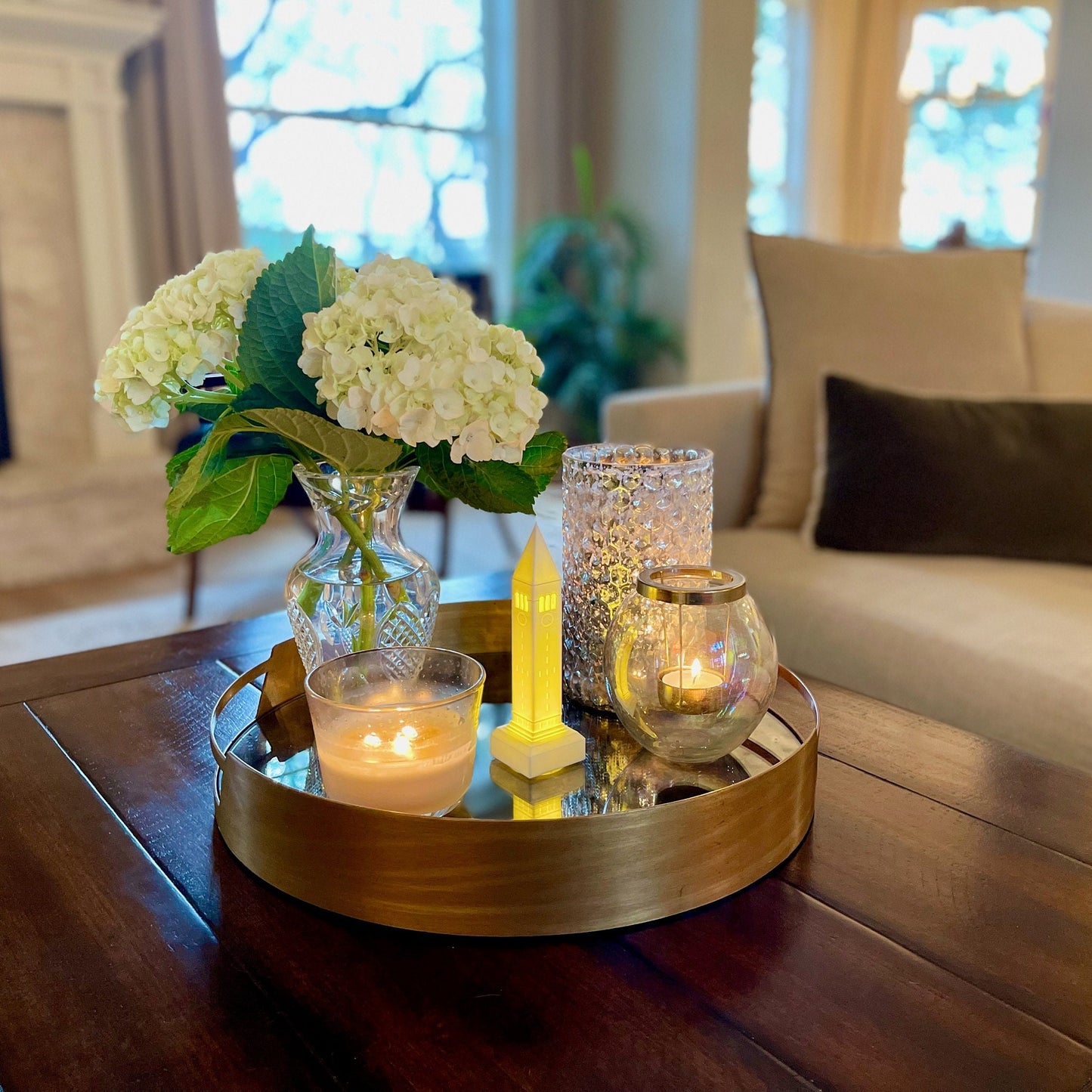 The lighted Cornell McGraw Tower figurine, shown in a living room.