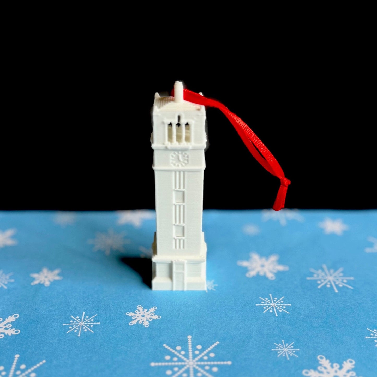 Front view of the NC State Christmas ornament, designed in honor of the NC State Bell Tower.