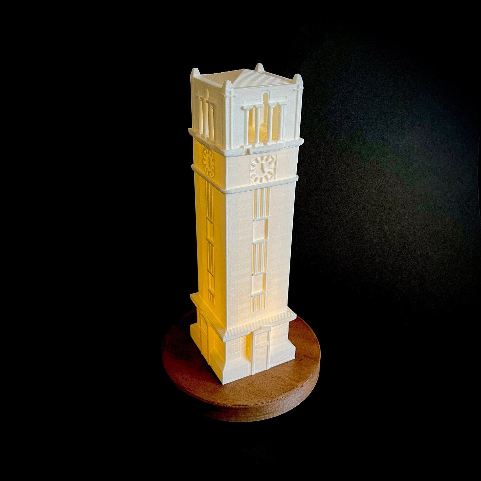 The NC State Bell Tower lamp, shown in white and displayed against a black background.