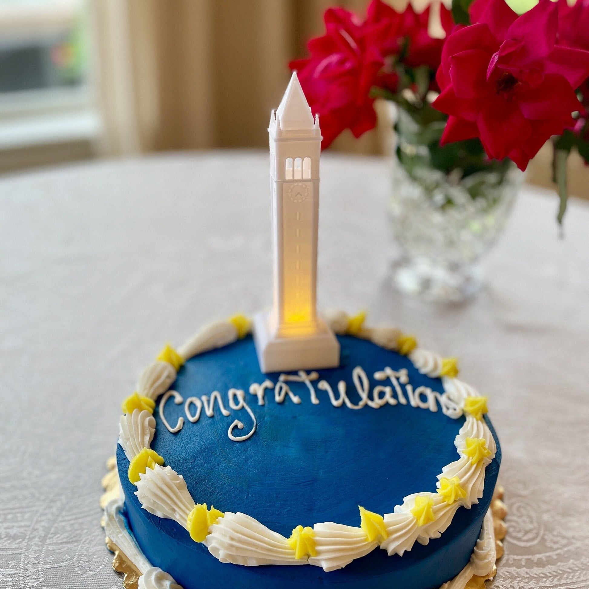 The lighted Berkeley cake topper, shown on a Berkeley graduation cake.