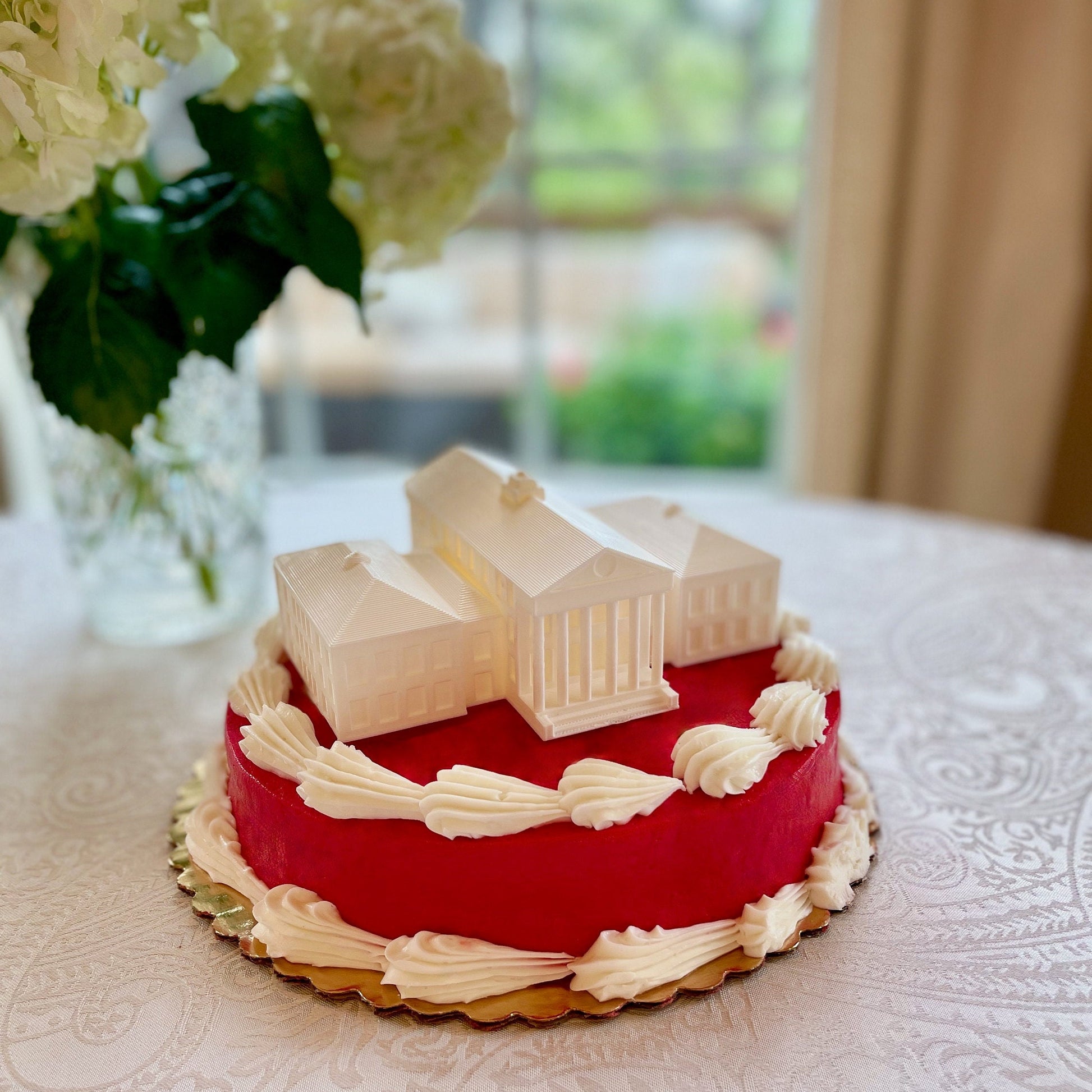 The University of Mississippi cake topper, shown on an Ole Miss graduation cake.