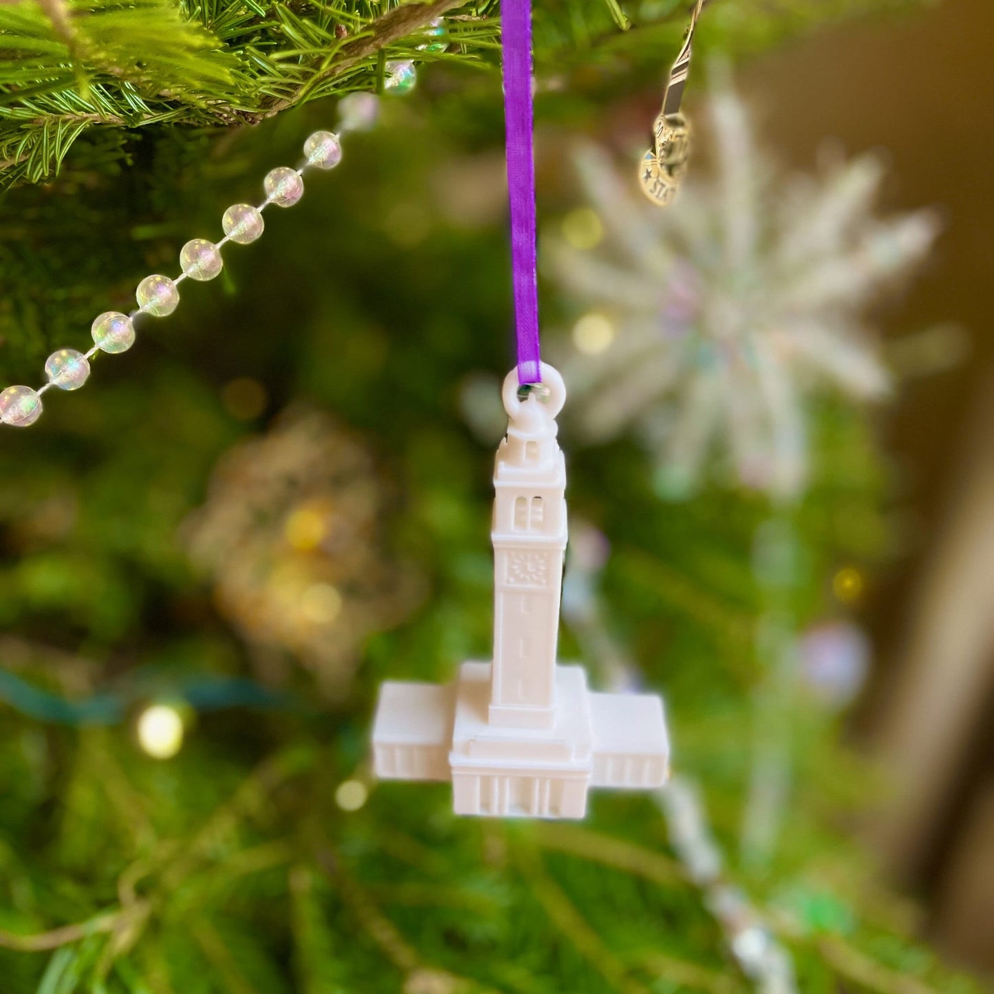 The 3D printed LSU ornament, shown on a Christmas tree.