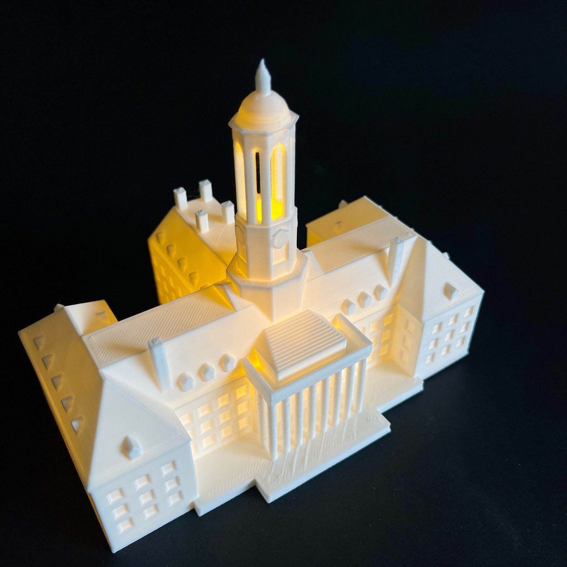 Top view of the lighed Penn State keepsake, designed as a replica of the Old Main Building.