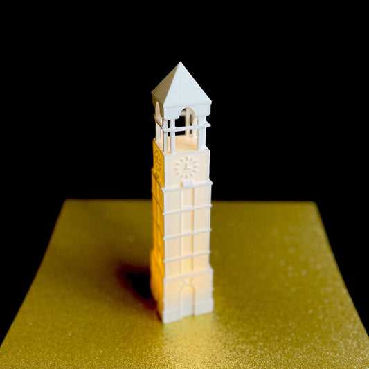 The lighted Purdue figurine, shown against a gold background.