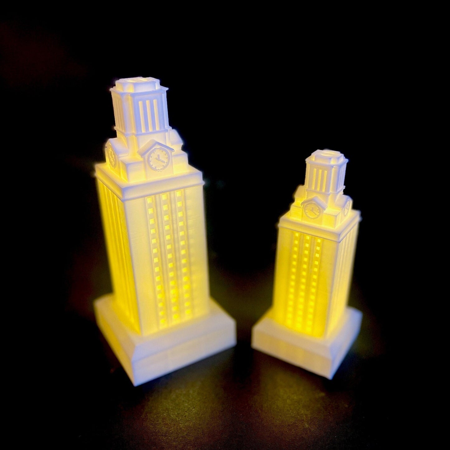 The white UT Tower figurines, shown in a soft white light.