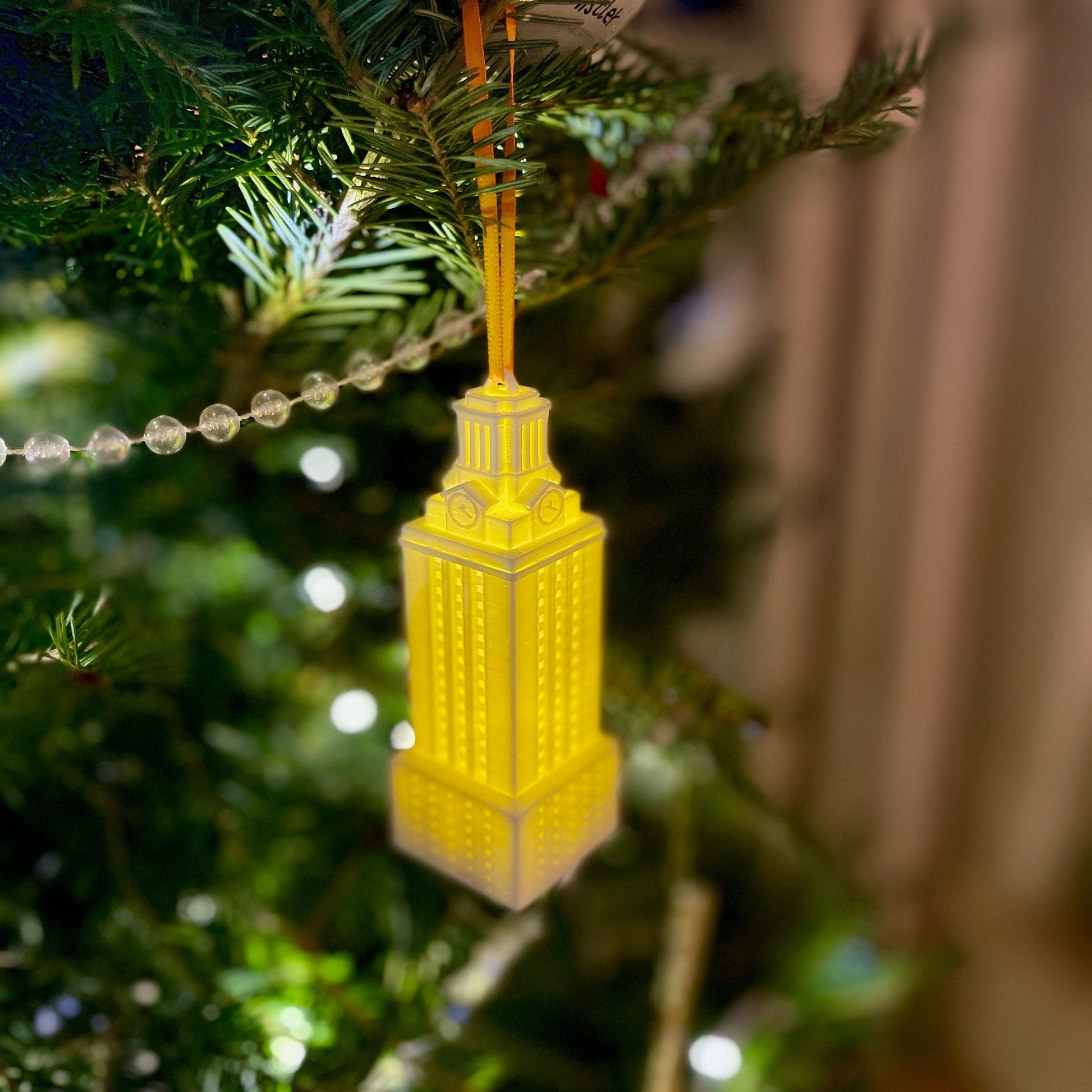 The lighted UT Austin ornament, shown in a home decorated for the Holidays.