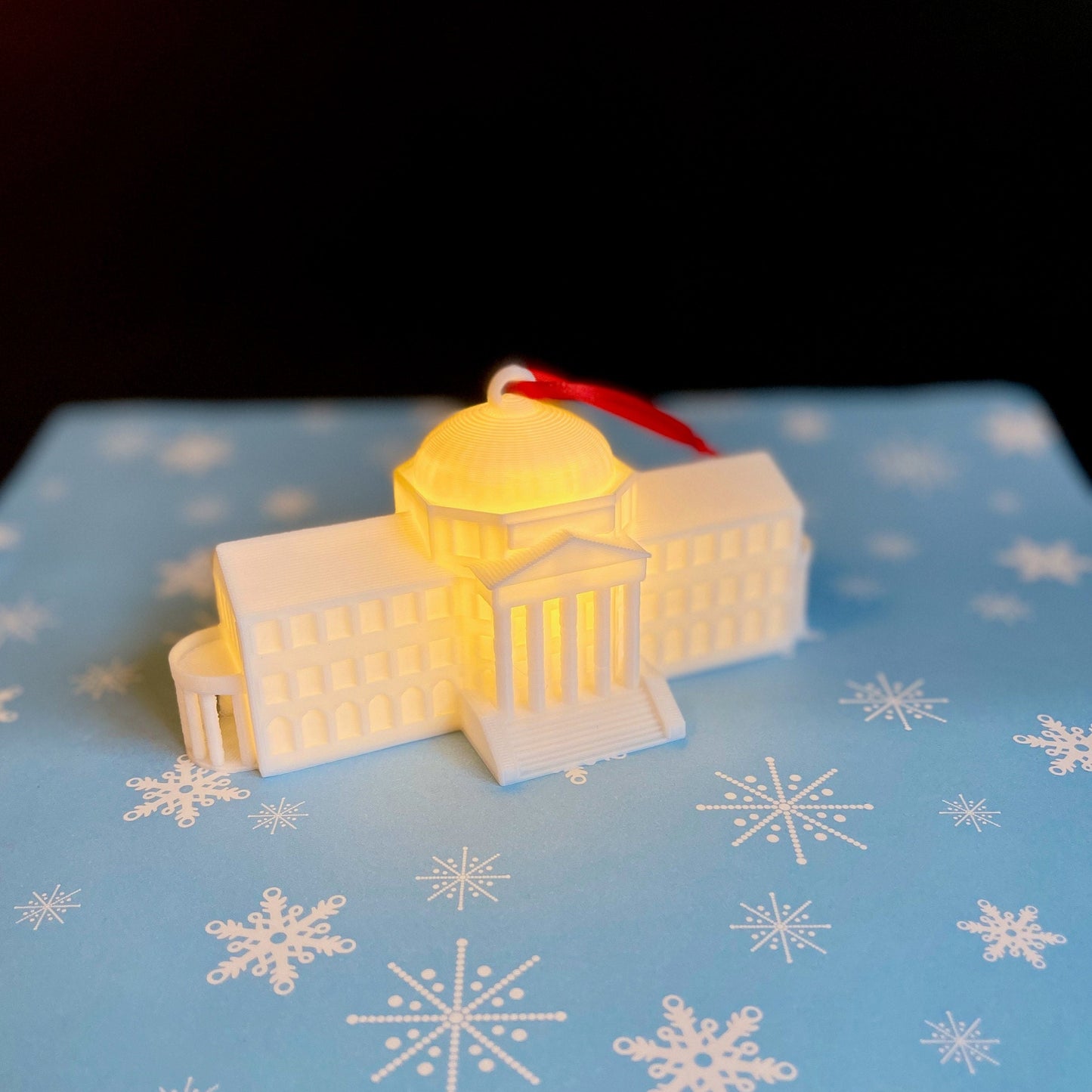 Detailed view of the lighted SMU ornament, designed as a replica of the SMU Dallas Hall.