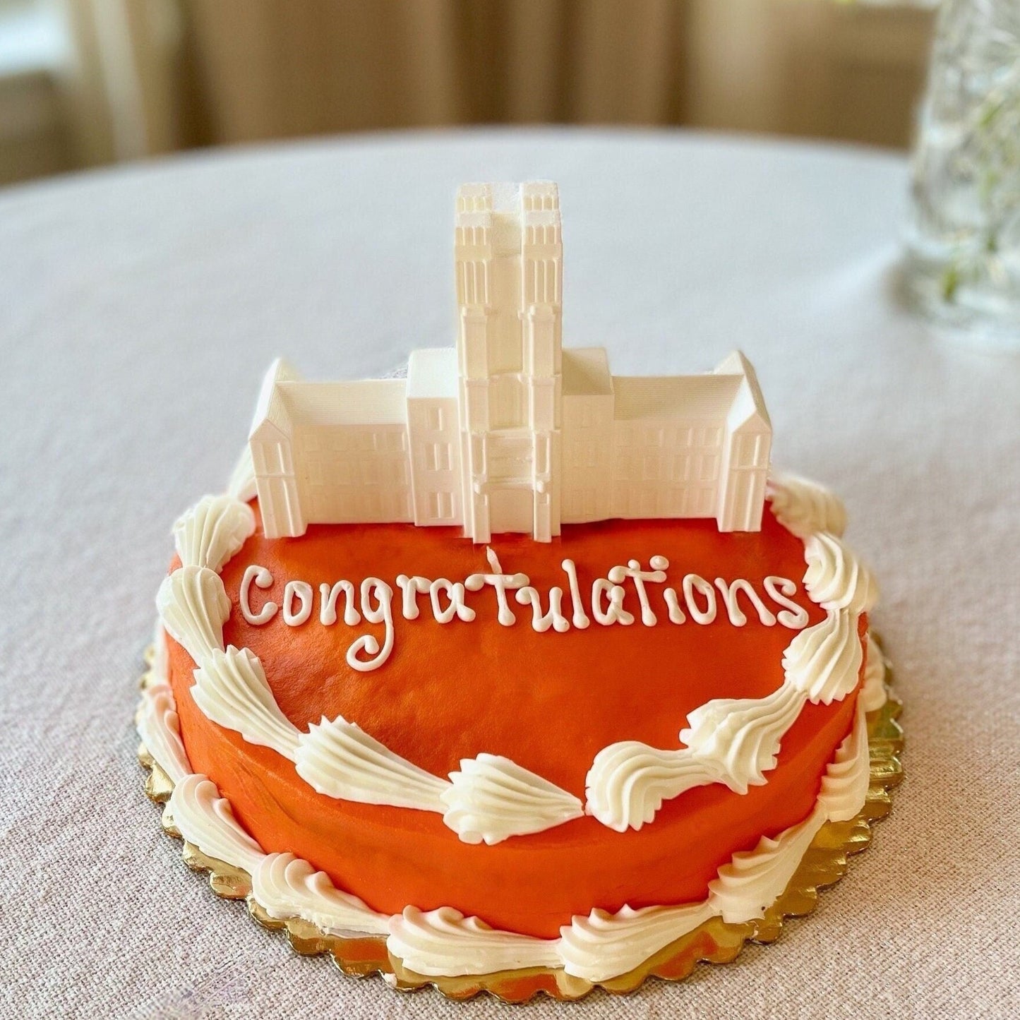 The Virginia Tech cake topper figurine, shown on an orange Virginia Tech graduation cake.