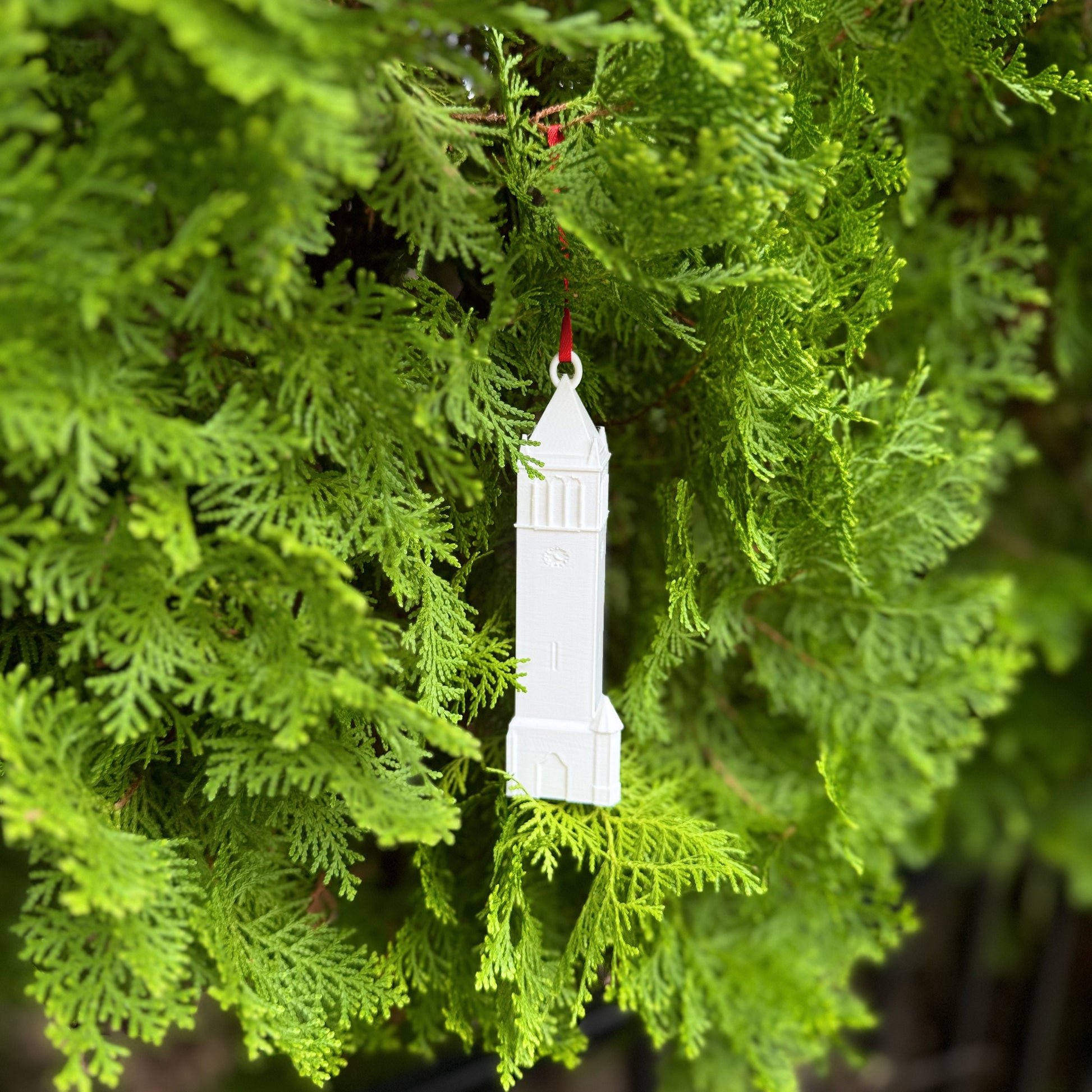 The Iowa State Campanile ornament, shown on a tree decorated for Christmas.