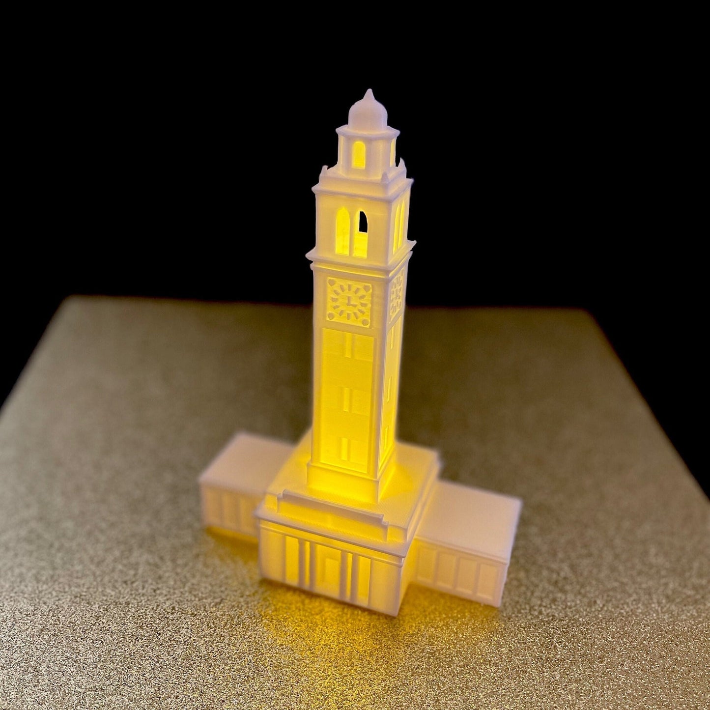 Front view of the LSU dorm decoration, designed in honor of the LSU Memorial Tower and shown against a gold background.