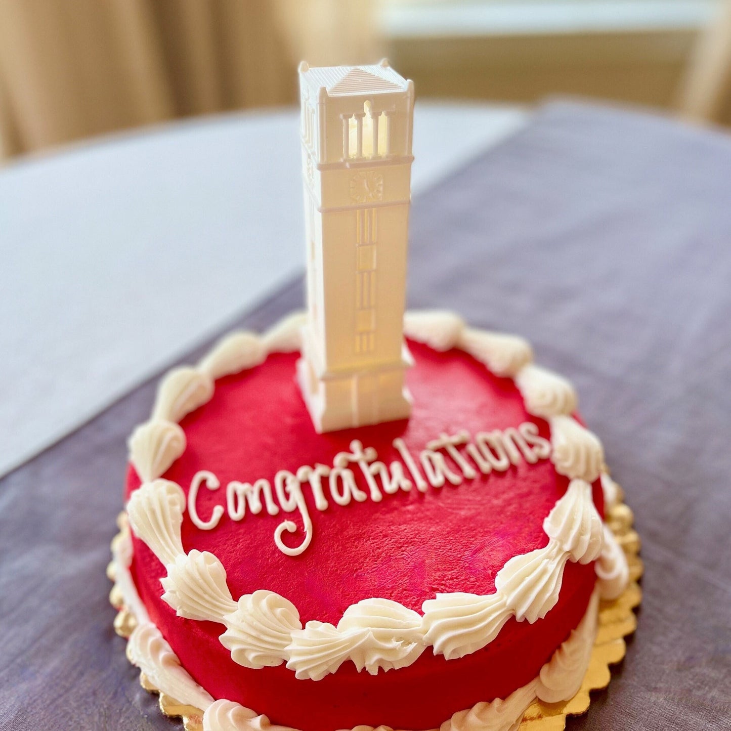 The lighted NC State cake topper, designed in honor of the NC State Bell Tower.