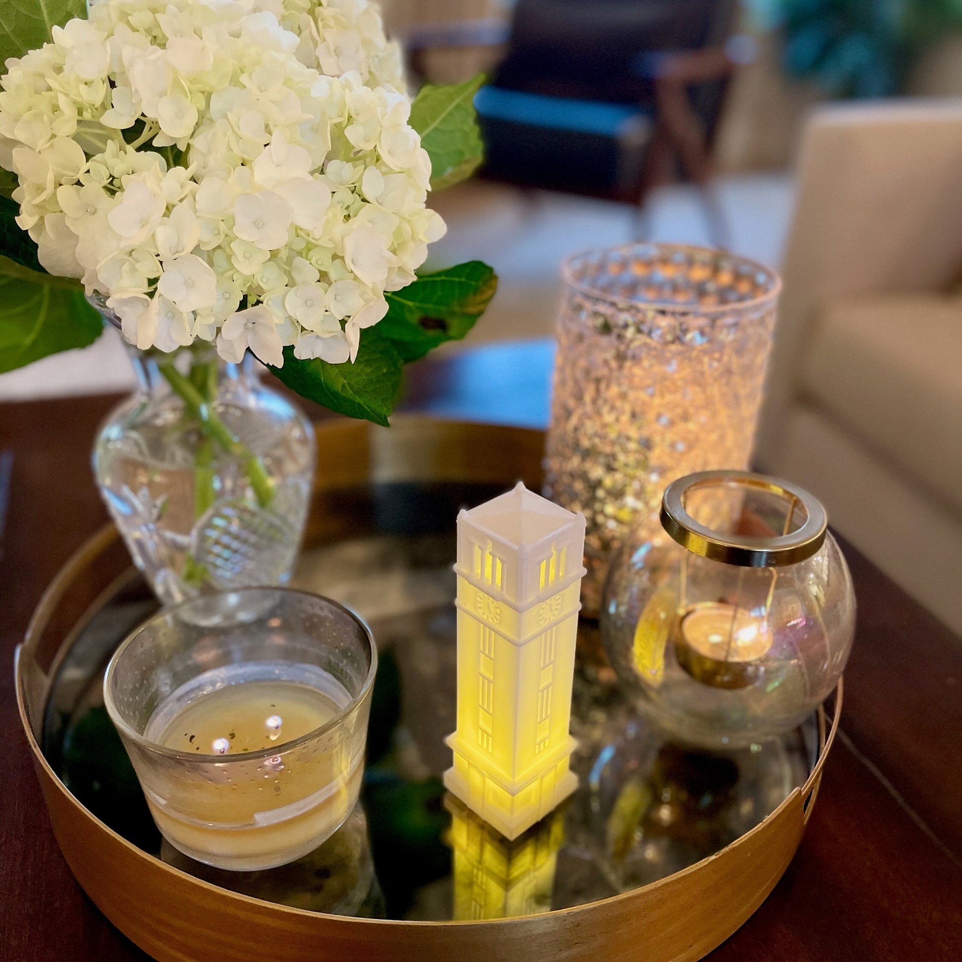 The NC State Bell Tower light, displayed on a living room tray.