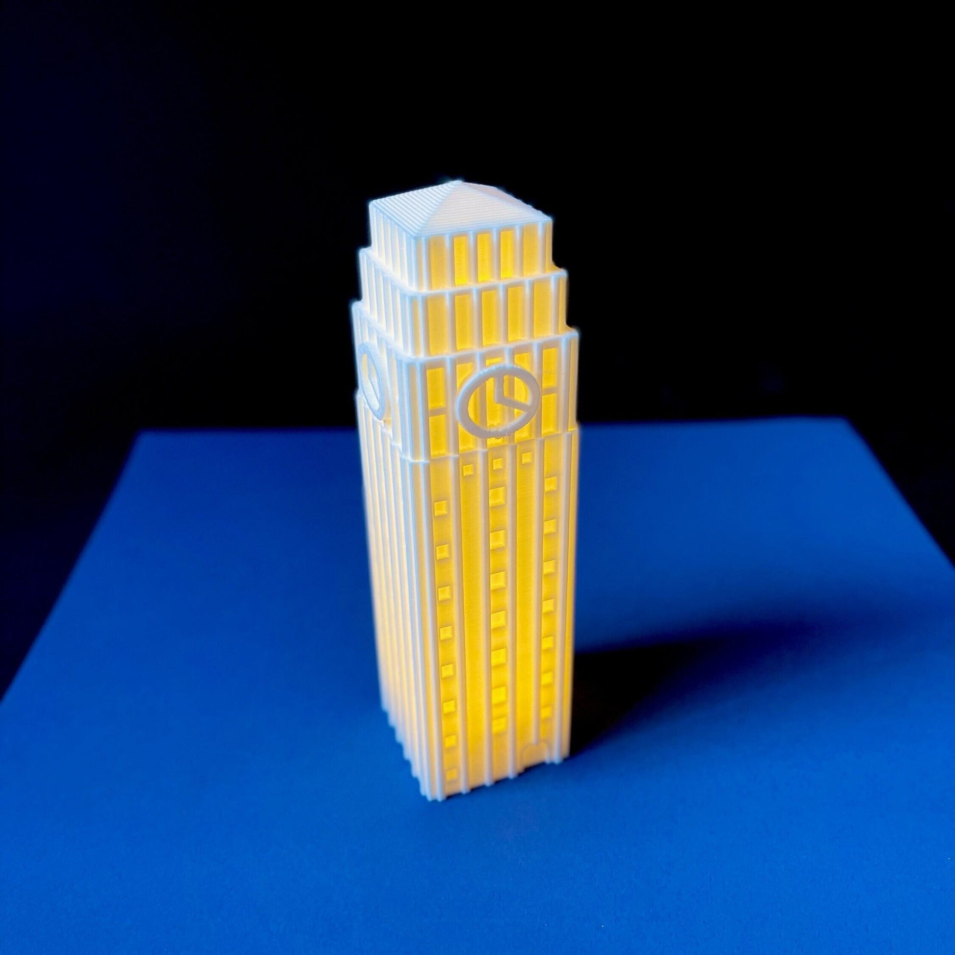 The lighted University of Michigan figurine, shown against a blue background.