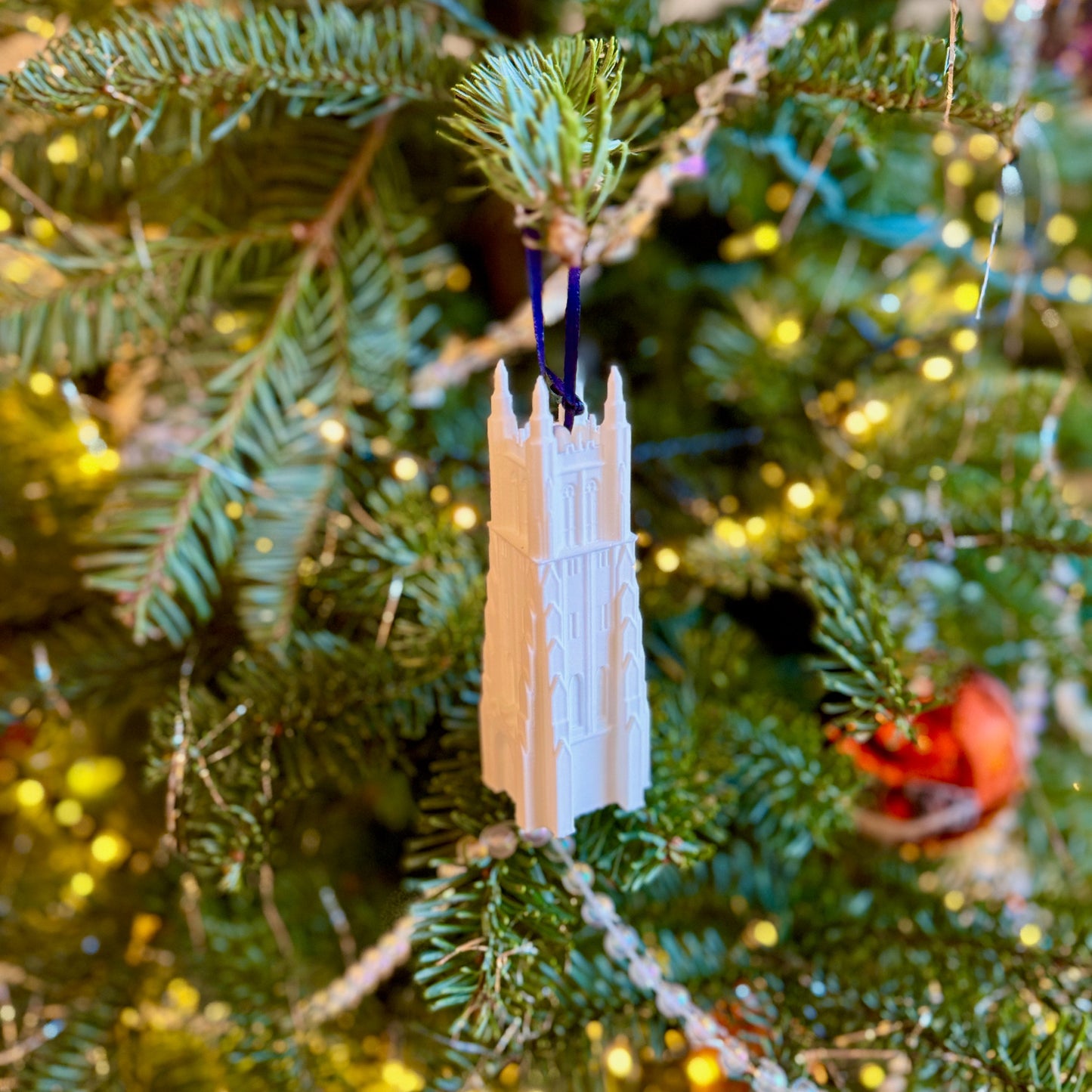 The Duke Chapel ornament, shown on a Christmas tree.