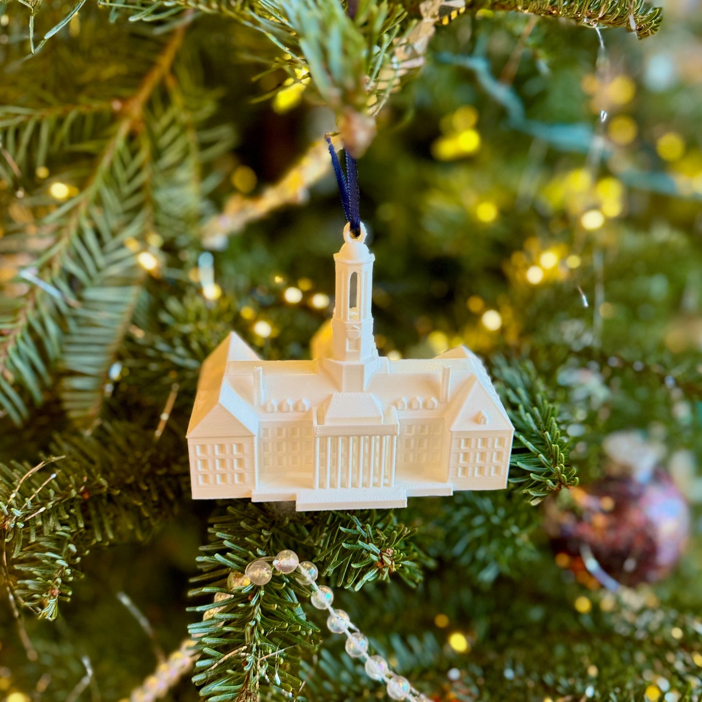 The Penn State campus ornament, shown on a Christmas tree.