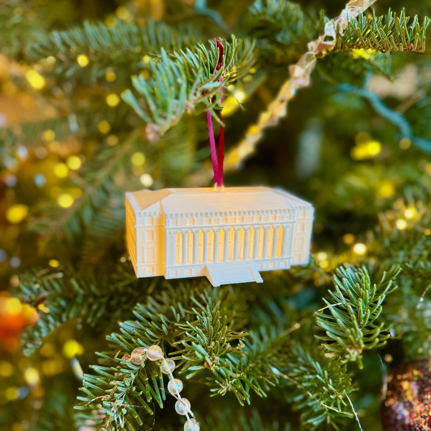 The Texas A&M lighted ornament, shown on a Christmas tree.