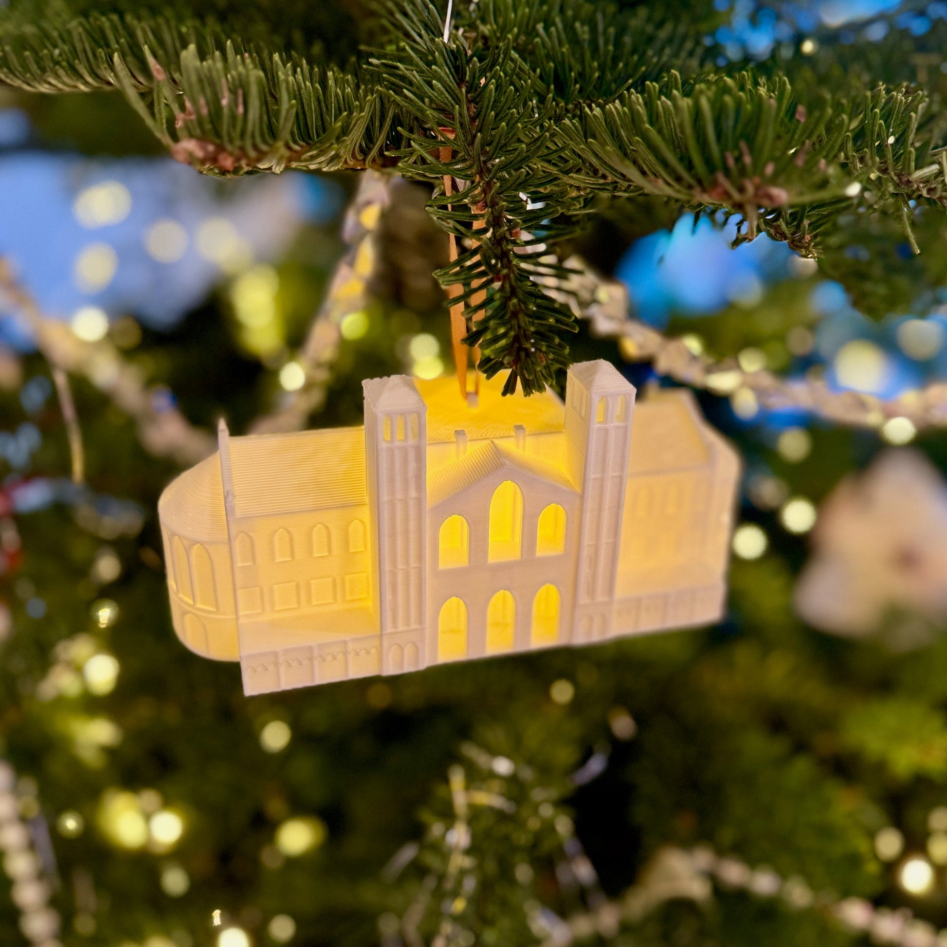 The lighted UCLA campus ornament, shown on a tree decorated for the holidays.